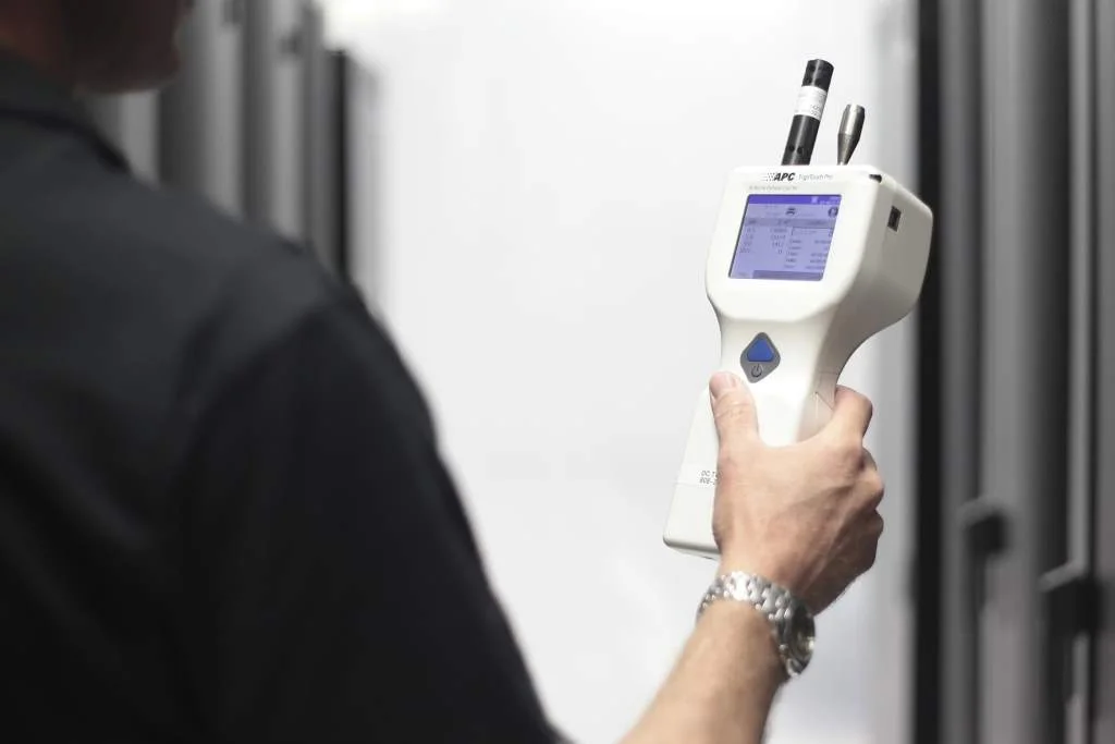checking indoor air quality with air quality testing device.